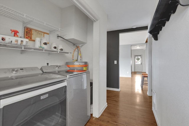 436 N Washington St, Tekoa, WA 99033 - washroom with washing machine and dryer, wood finished floors, and baseboards