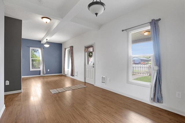 436 N Washington St, Tekoa, WA 99033 - foyer with beam ceiling, baseboards, and hardwood / wood-style floors