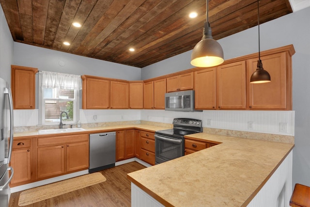 436 N Washington St, Tekoa, WA 99033 - kitchen featuring appliances with stainless steel finishes, a sink, a peninsula, wooden ceiling, and wood finished floors