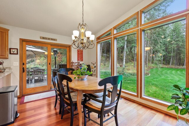 5999 E Roger Dr, Post Falls, ID 83854 - dining area featuring light wood-type flooring and a chandelier