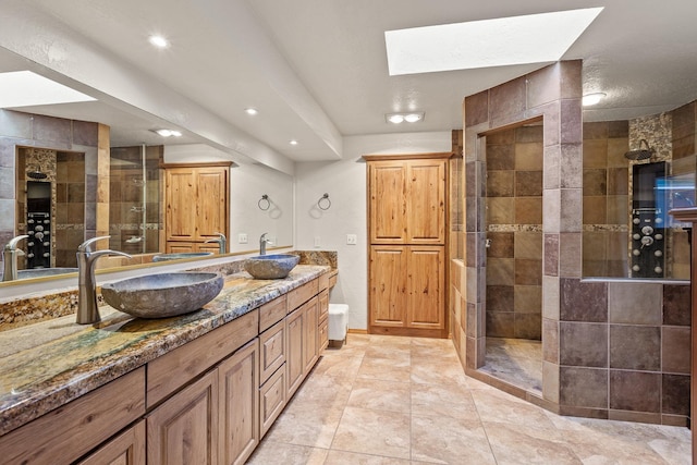 5999 E Roger Dr, Post Falls, ID 83854 - full bathroom featuring double vanity, a shower stall, recessed lighting, and a skylight