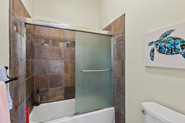 5999 E Roger Dr, Post Falls, ID 83854 - bathroom featuring toilet and enclosed tub / shower combo