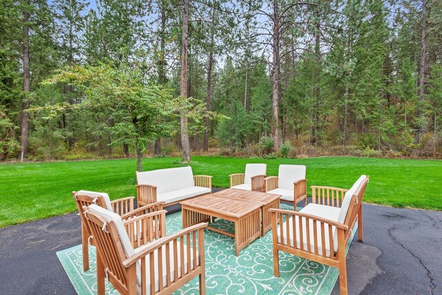 5999 E Roger Dr, Post Falls, ID 83854 - view of patio / terrace with outdoor lounge area and a view of trees