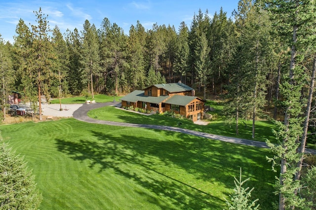 5999 E Roger Dr, Post Falls, ID 83854 - surrounding community with a lawn and a forest view
