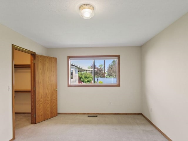 1946 S Century Ln, Spokane Valley, WA 99037 - unfurnished bedroom with light colored carpet, a walk in closet, and a closet