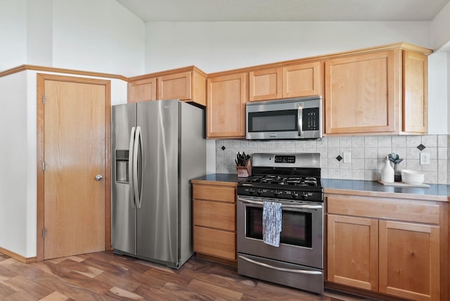 13013 E 37th Ct, Spokane Valley, WA 99206 - kitchen featuring stainless steel appliances, tasteful backsplash, light brown cabinetry, dark wood-type flooring, and high vaulted ceiling