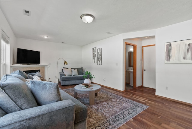 13013 E 37th Ct, Spokane Valley, WA 99206 - living area with wood finished floors, baseboards, and a fireplace