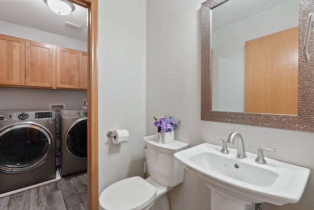 13013 E 37th Ct, Spokane Valley, WA 99206 - bathroom featuring washer and clothes dryer, wood finished floors, a sink, and toilet