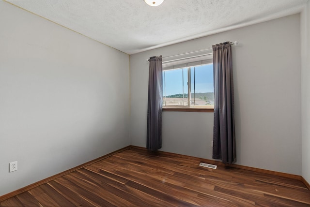 13013 E 37th Ct, Spokane Valley, WA 99206 - empty room with dark wood-style flooring, a textured ceiling, and baseboards