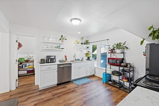 368 E 7th Ave, Spokane, WA 99202 - kitchen with stainless steel appliances, a sink, light countertops, wood finished floors, and a textured ceiling