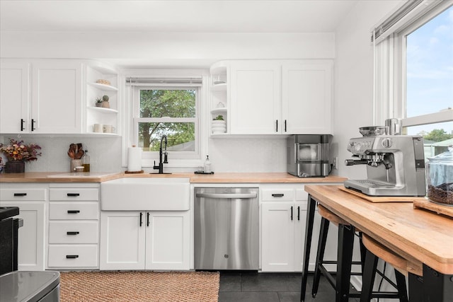 524 E Garland Ave, Spokane, WA 99207 - kitchen with dishwasher, a sink, open shelves, wooden counters, and tile patterned floors