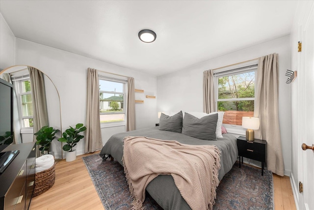 524 E Garland Ave, Spokane, WA 99207 - bedroom with multiple windows, light wood-type flooring, and arched walkways
