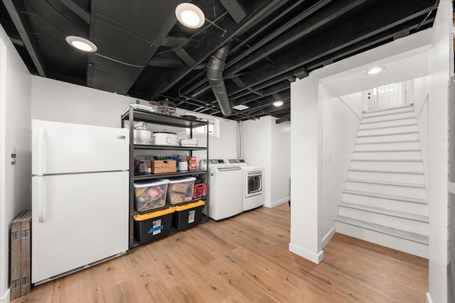 524 E Garland Ave, Spokane, WA 99207 - basement with freestanding refrigerator, light wood-type flooring, separate washer and dryer, and stairs