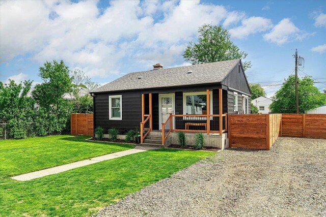 524 E Garland Ave, Spokane, WA 99207 - bungalow-style home with a chimney, roof with shingles, and a porch