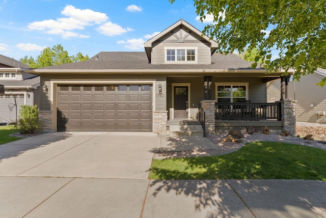1790 N Winchester St, Liberty Lake, WA 99019 - craftsman-style house featuring a garage, concrete driveway, covered porch, and stone siding
