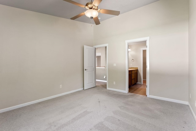 1790 N Winchester St, Liberty Lake, WA 99019 - unfurnished bedroom featuring light carpet, baseboards, ensuite bath, and a ceiling fan