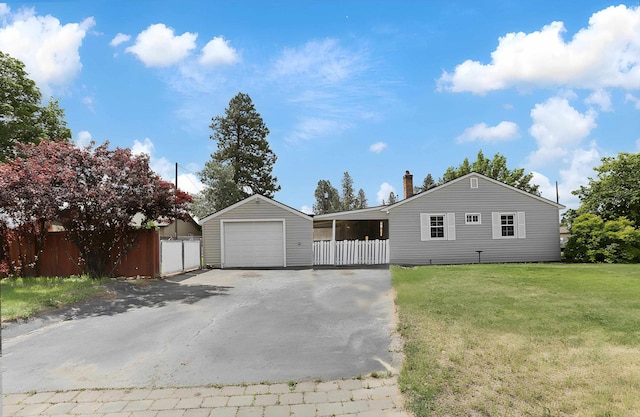 5824 N Washington St, Spokane, WA 99205 - ranch-style home featuring asphalt driveway, a detached garage, and a chimney