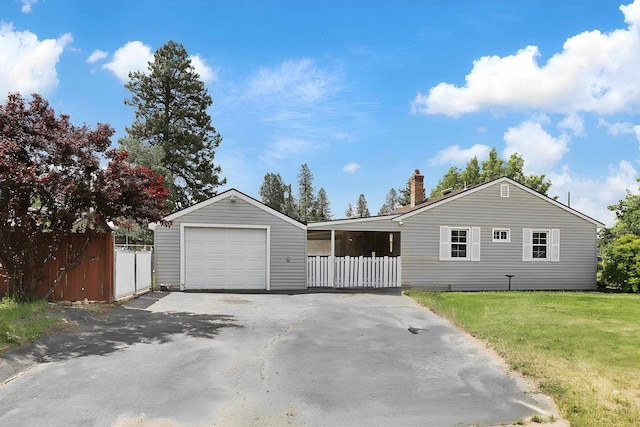 5824 N Washington St, Spokane, WA 99205 - view of front of property with a detached garage, driveway, and a chimney