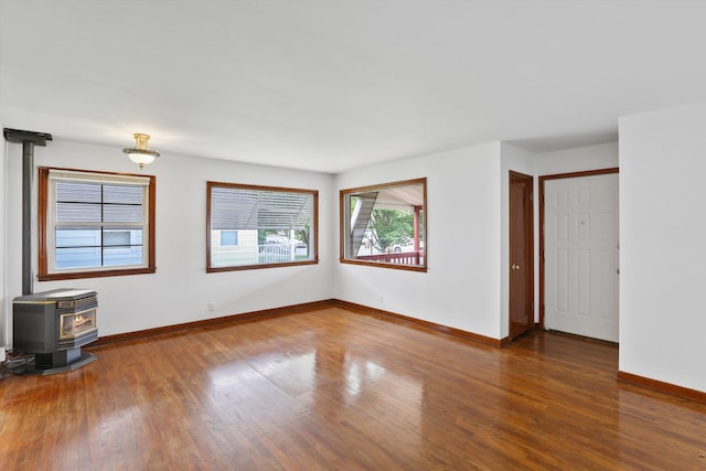 5824 N Washington St, Spokane, WA 99205 - spare room with a wood stove, wood finished floors, and baseboards