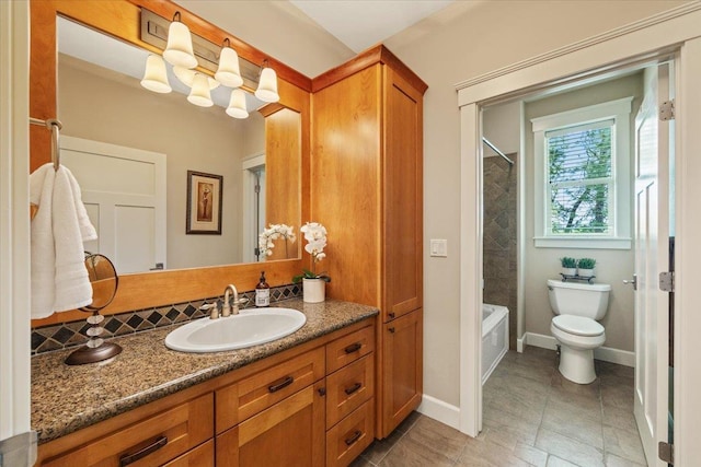 3311 E Chisholm Ln, Spokane, WA 99223 - bathroom featuring vanity, toilet, washtub / shower combination, and baseboards