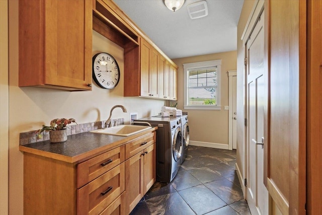 3311 E Chisholm Ln, Spokane, WA 99223 - washroom with cabinet space, washing machine and dryer, and baseboards