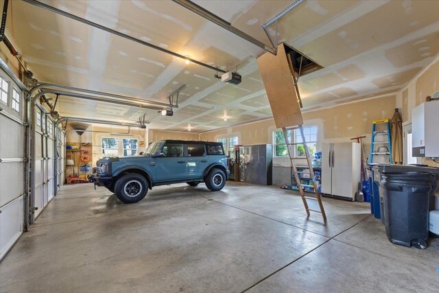 3311 E Chisholm Ln, Spokane, WA 99223 - garage with freestanding refrigerator and a garage door opener