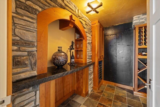 3311 E Chisholm Ln, Spokane, WA 99223 - wine cellar with stone tile flooring and arched walkways