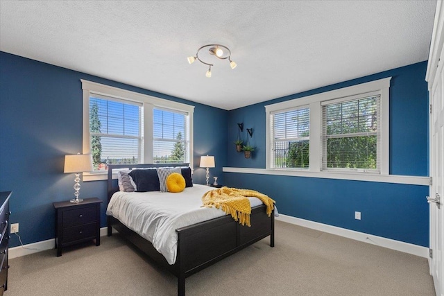 3311 E Chisholm Ln, Spokane, WA 99223 - carpeted bedroom with multiple windows, baseboards, and a textured ceiling