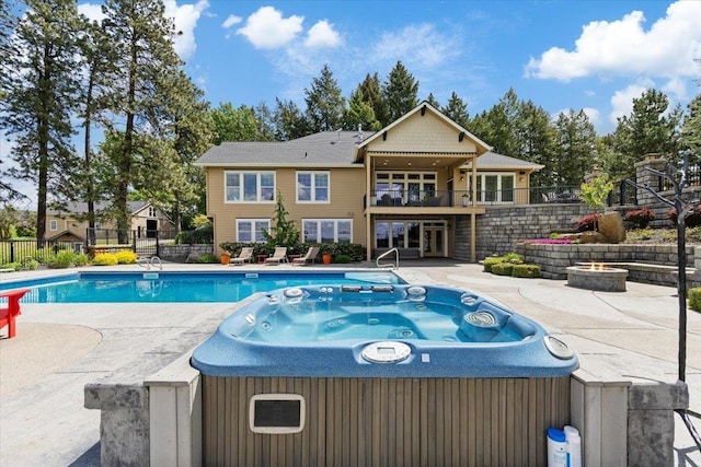 3311 E Chisholm Ln, Spokane, WA 99223 - back of house featuring a hot tub, a patio, a fire pit, and a balcony