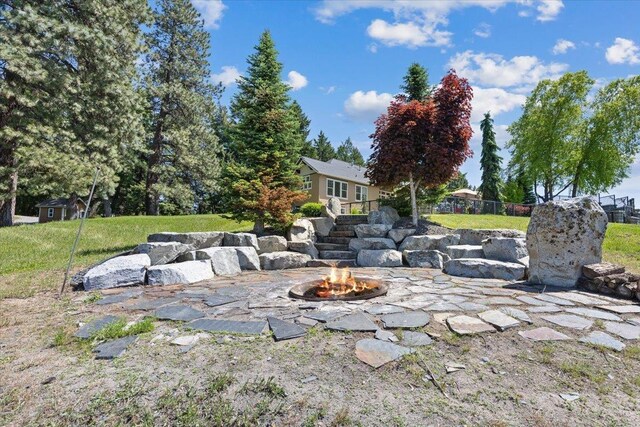 3311 E Chisholm Ln, Spokane, WA 99223 - view of green lawn with an outdoor fire pit and a patio area