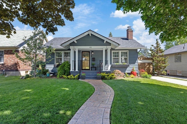 48 W 28th Ave, Spokane, WA 99203 - bungalow-style house with a chimney, a front lawn, and roof with shingles