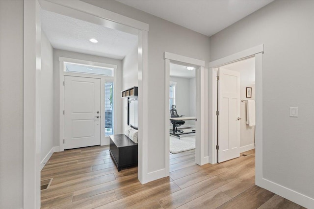 19661 E Riverwalk Ave, Liberty Lake, WA 99016 - foyer entrance with light wood-type flooring and baseboards