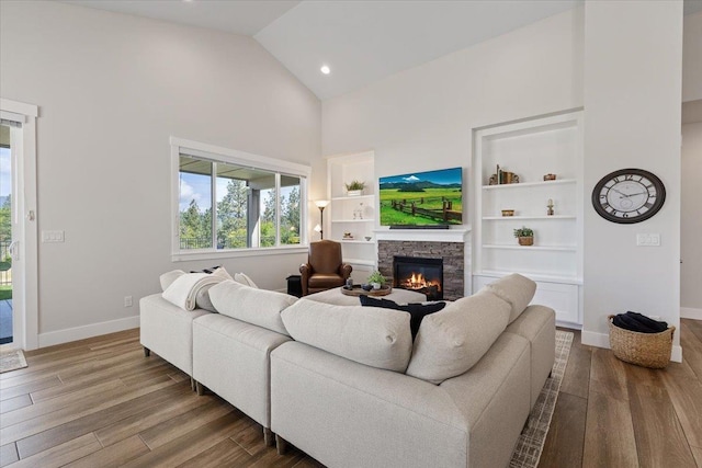19661 E Riverwalk Ave, Liberty Lake, WA 99016 - living area featuring high vaulted ceiling, a fireplace, baseboards, dark wood-style floors, and recessed lighting