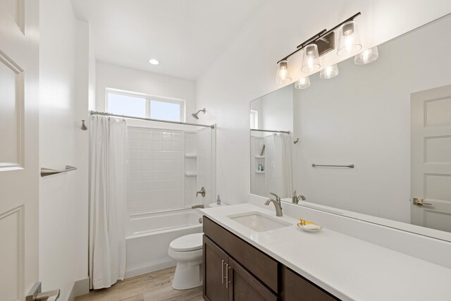 2418 N Atlas Rd, Coeur D Alene, ID 83814 - bathroom featuring vanity, shower / bath combo with shower curtain, toilet, and wood finished floors