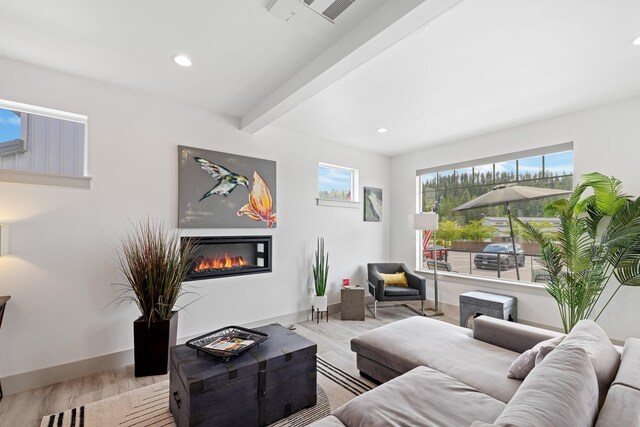 2418 N Atlas Rd, Coeur D Alene, ID 83814 - living room featuring light wood-style floors, baseboards, recessed lighting, and a glass covered fireplace