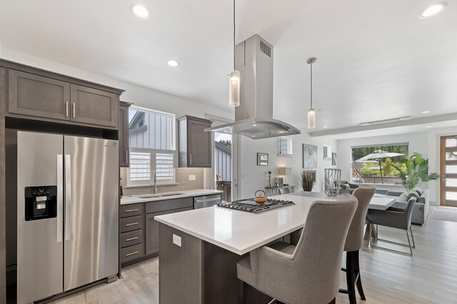 2418 N Atlas Rd, Coeur D Alene, ID 83814 - kitchen featuring backsplash, light wood-style flooring, recessed lighting, light countertops, and dark brown cabinetry