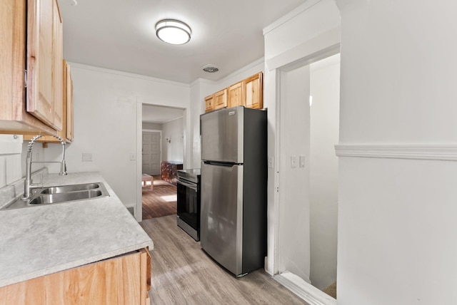 2708 W Boone Ave, Spokane, WA 99201 - kitchen featuring stainless steel appliances, a sink, light wood-type flooring, light brown cabinetry, and light countertops