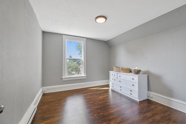 2512 E Rowan Ave, Spokane, WA 99217 - unfurnished bedroom with wood finished floors, vaulted ceiling, and baseboards
