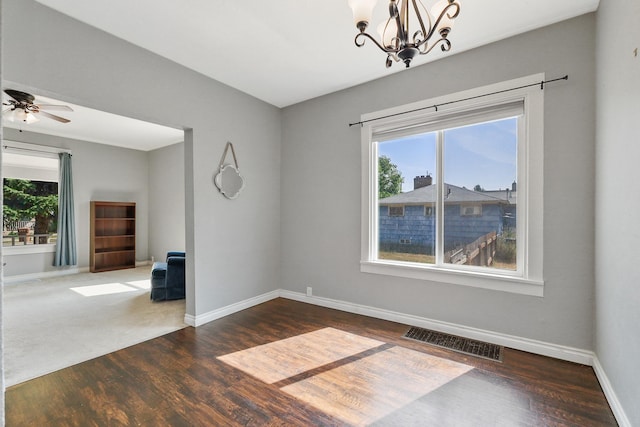 2512 E Rowan Ave, Spokane, WA 99217 - unfurnished room with wood finished floors, a chandelier, baseboards, and a ceiling fan