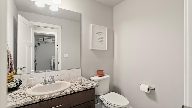 4011 S University Ct, Spokane Valley, WA 99206 - half bathroom with tasteful backsplash, toilet, vanity, and washer / dryer