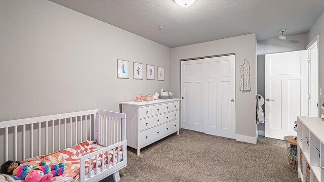 4011 S University Ct, Spokane Valley, WA 99206 - bedroom with carpet, a closet, baseboards, and a crib
