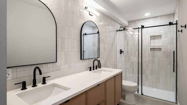 4011 S University Ct, Spokane Valley, WA 99206 - bathroom with tile walls, toilet, a stall shower, double vanity, and tile patterned floors