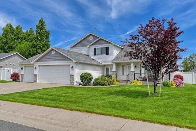 822 N Kelsea St, Medical Lake, WA 99022 - view of front of property with an attached garage, concrete driveway, covered porch, a shingled roof, and stone siding