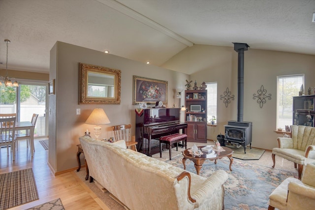 822 N Kelsea St, Medical Lake, WA 99022 - living area with a wood stove, light wood finished floors, a textured ceiling, and baseboards
