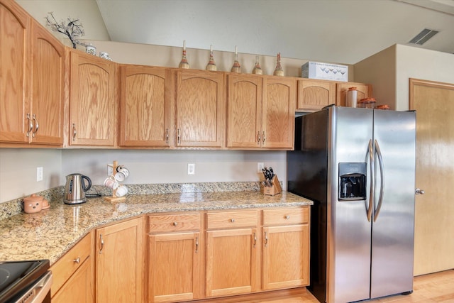 822 N Kelsea St, Medical Lake, WA 99022 - kitchen with stainless steel refrigerator with ice dispenser, light wood-style floors, and light stone counters