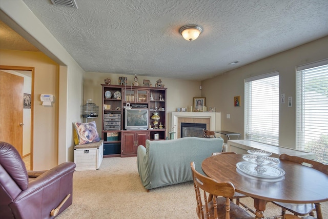 822 N Kelsea St, Medical Lake, WA 99022 - living room featuring a tile fireplace, light colored carpet, and a textured ceiling