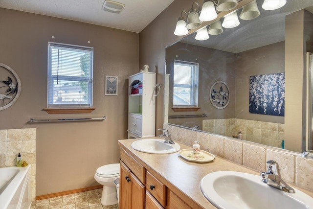 822 N Kelsea St, Medical Lake, WA 99022 - bathroom with healthy amount of natural light, a bath, double vanity, and baseboards