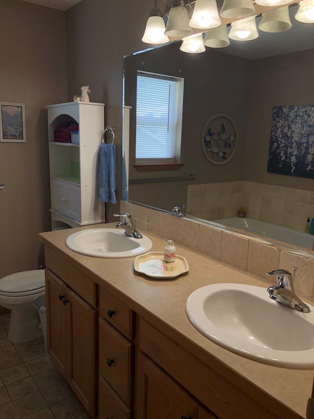 822 N Kelsea St, Medical Lake, WA 99022 - full bath featuring double vanity, toilet, a garden tub, and tile patterned flooring