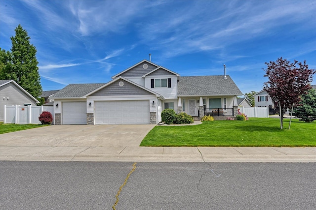 822 N Kelsea St, Medical Lake, WA 99022 - view of front of property featuring an attached garage, driveway, stone siding, and a porch