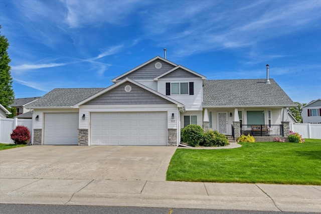 822 N Kelsea St, Medical Lake, WA 99022 - view of front of house featuring a garage, driveway, stone siding, covered porch, and roof with shingles